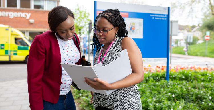 two ladies talking outside a medical centre