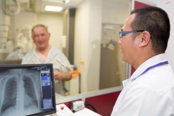 doctor looking at an xray on a computer screen