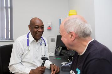 General Practitioner treating an elderly man