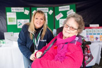 Elderly lady in a wheelchair with her carer